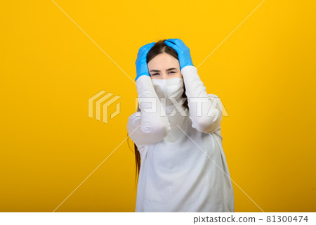 Girl in medical gloves dress a medical mask on her face on a background. Respiratory disease. Covid-19 81300474