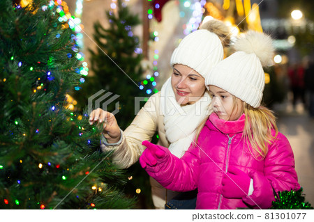 Friendly family of mother and daughter having fun on outdoor fair Friendly family of mother and daughter having fun on outdoor fair 81301077