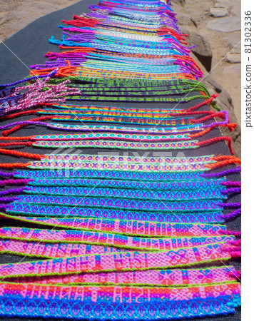 Many handmade misanga lined up as souvenirs in Peru 81302336