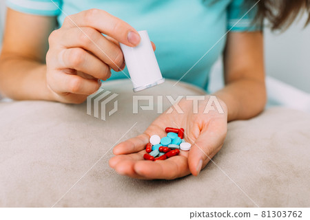 Caucasian woman wants to commit suicide by drinking pills 81303762