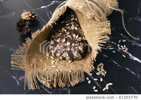Rye bread baked with sesame , linseeds and sunflower seeds. 81303770