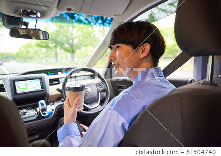 Young man driving a car 81304740