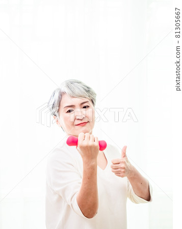 Healthy lifestyle. Smiling Asia mature female layperson powder red bell training Healthy lifestyle. Smiling Asia mature female layperson powder red bell training 81305667