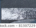 Zebra crossway with some faded on asphalt road close-up view 81307229