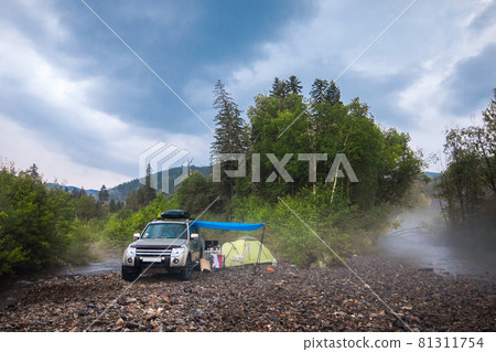 Car camping at mountain river 81311754