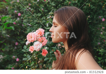 Woman in roses garden Woman in roses garden 81312928