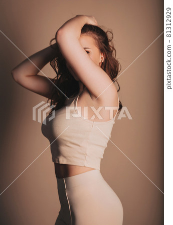Happy woman smiling and touching hair Happy woman smiling and touching hair 81312929