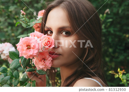 Woman in roses garden Woman in roses garden 81312930