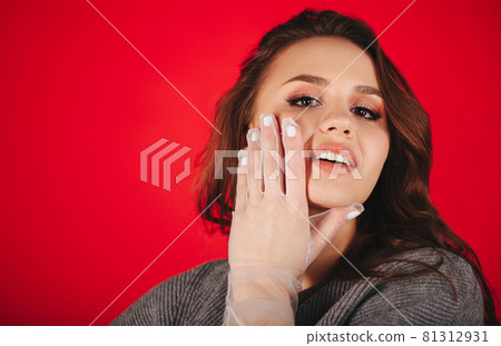 Trendy female model touching face 81312931