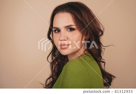 Young pensive brunette woman with serious facial expression standing sideways Young pensive brunette woman with serious facial expression standing sideways 81312933