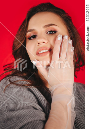 Trendy female model touching face Trendy female model touching face 81312935
