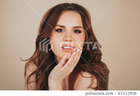 Happy woman smiling and touching her face Happy woman smiling and touching her face 81312936