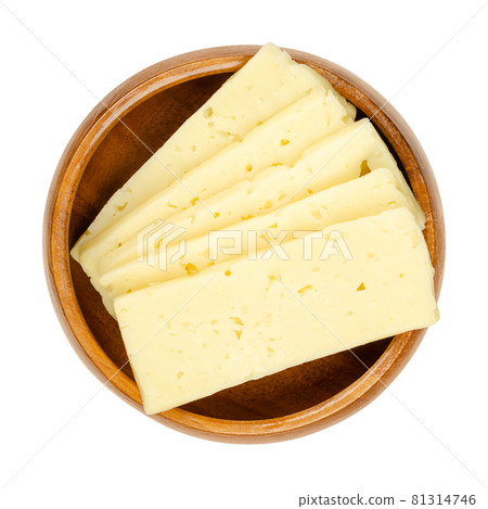 Tilsit cheese slices, in a wooden bowl. Sliced Tilsiter cheese, a pale yellow semi hard smear-ripened cheese, with a medium-firm texture and irregular holes or cracks, made from pasteurized cow milk. Tilsit cheese slices, in a wooden bowl. Sliced Tilsiter cheese, a pale yellow semi hard smear-ripened cheese, with a medium-firm texture and irregular holes or cracks, made from pasteurized cow milk. 81314746