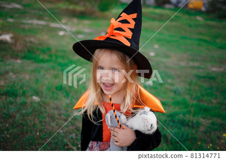 little cute girl dressed as a witch celebrates halloween 81314771