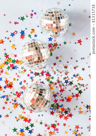 Disco ball on blue background with multicolored stars confetti  81315738