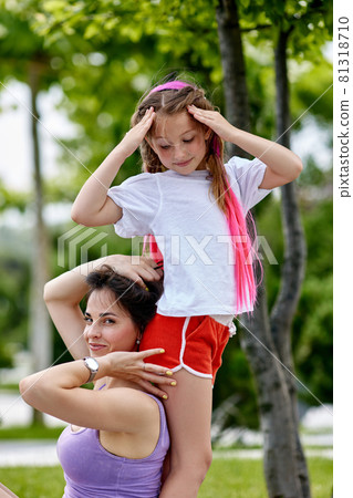 child girl and her mother having fun in park. child girl and her mother having fun in park. 81318710
