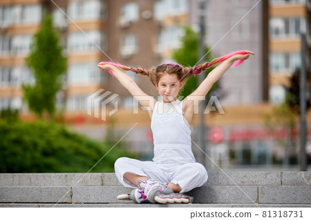 cute little girl on roller skates at park. cute little girl on roller skates at park. 81318731