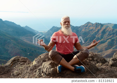 Senior man greeting sunset 81318921