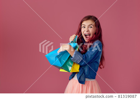 little caucasian child girl holds shopping bags 81319087