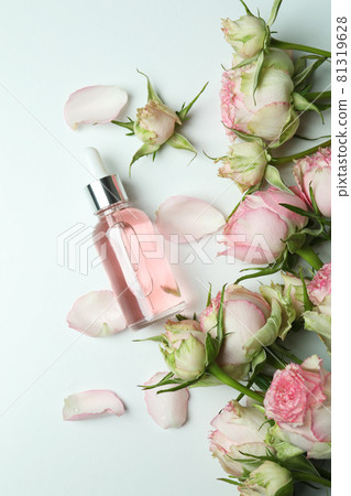 Skin care concept with essential rose oil on white background, top view 81319628