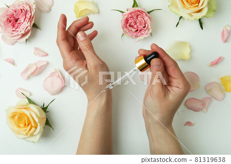 Female hands hold pipette with rose essential oil 81319638