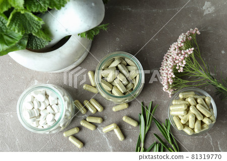 Concept of herbal medicine pills on gray textured background 81319770