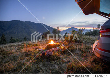 Beautiful picnic with a campfire in the mountains Beautiful picnic with a campfire in the mountains 81320283