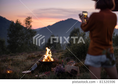 Woman at picnic in the mountains Woman at picnic in the mountains 81320306