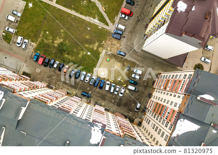 Aerial view of parked cars on parking lot between high apartment buildings. Aerial view of parked cars on parking lot between high apartment buildings. 81320975