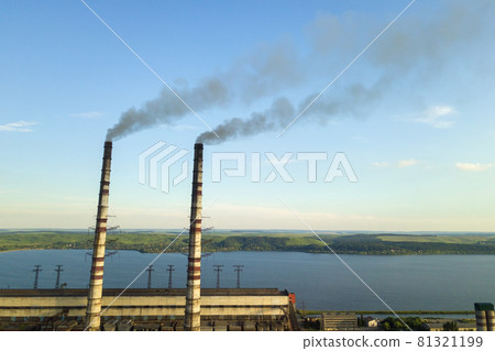 Aerial view of coal power plant high pipes with black smoke moving up polluting atmosphere. Aerial view of coal power plant high pipes with black smoke moving up polluting atmosphere. 81321199