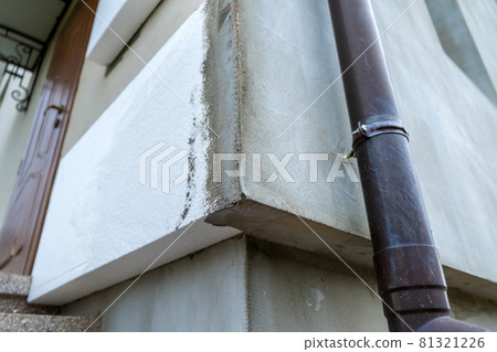 Installation of styrofoam insulation sheets on house facade wall for thermal protection. Installation of styrofoam insulation sheets on house facade wall for thermal protection. 81321226