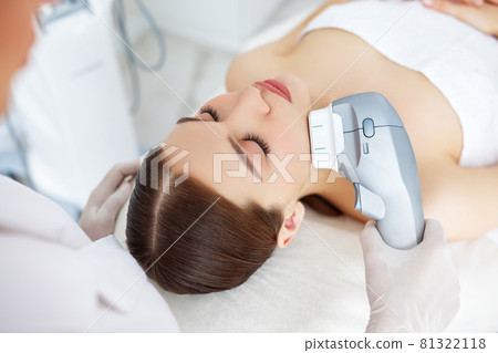 Woman getting facial lifting therapy in beauty salon 81322118