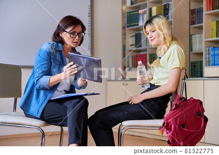 Woman school psychologist teacher talking and helping student, female teenager 81322775