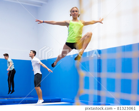 Woman exercising on trampoline Woman exercising on trampoline 81323061
