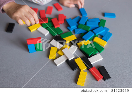 A child playing building blocks dominoes at a summer vacation house A child playing building blocks dominoes at a summer vacation house 81323929