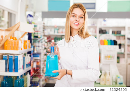 Pharmacist offering medicine in pharmacy Pharmacist offering medicine in pharmacy 81324203