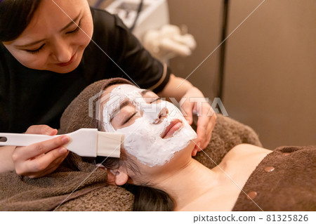 A woman undergoing treatment at a facial beauty salon A woman undergoing treatment at a facial beauty salon 81325826