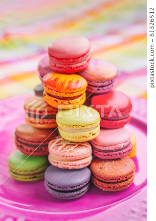 Macarons tower french pastries sweet dessert from Paris bakery. Vertical crop of colorful parisian bites of meringue cookies 81326512