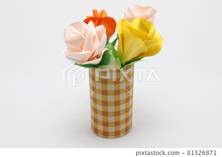Handmade rose flowers made from origami are displayed in a beautiful vase 81326871
