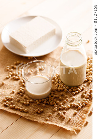 soy milk in a bottle on wooden table soy milk in a bottle on wooden table 81327159