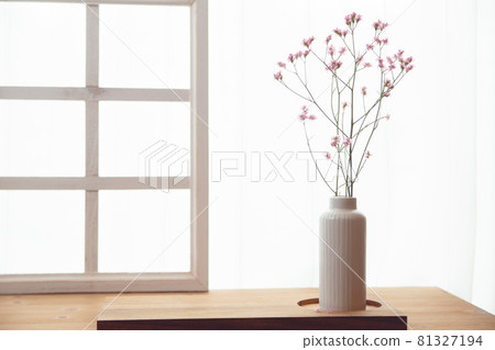 Pink flowers in a vase to decorate the window of the room. Copy space. Pink flowers in a vase to decorate the window of the room. Copy space. 81327194