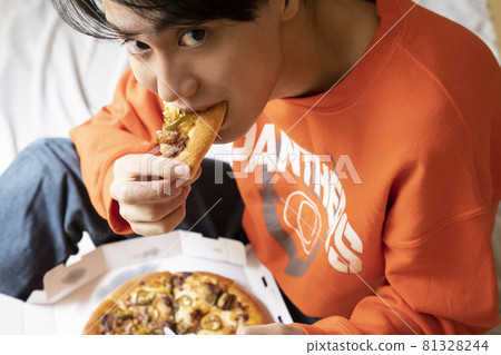 男人在房間裡吃披薩 男人在房間裡吃披薩 81328244