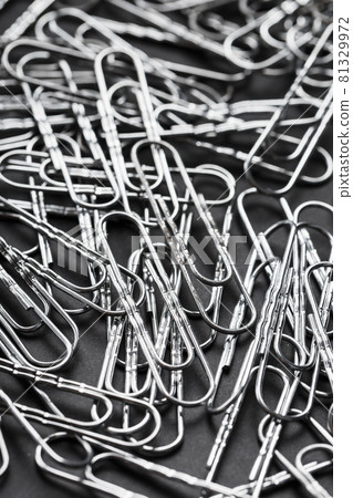Silver Paper clips scattered as textured background Silver Paper clips scattered as textured background 81329972