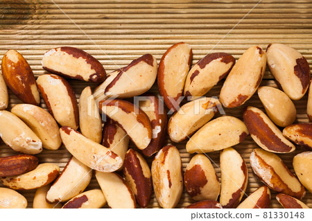 Brazil nuts on light wood surface 81330148