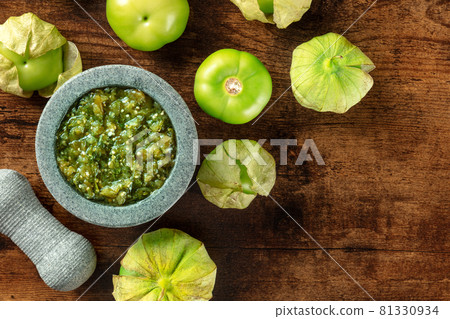 Tomatillos, green tomatoes, with salsa verde, green sauce, in a molcajete 81330934