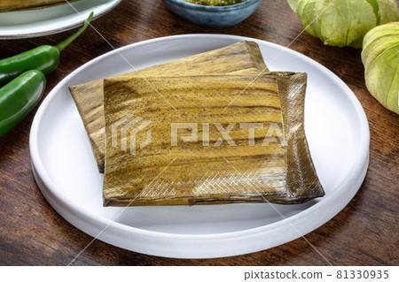 Tamales, traditional dish of the cuisine of Mexico, on a wooden background Tamales, traditional dish of the cuisine of Mexico, on a wooden background 81330935