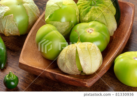 Tomatillos, green tomatoes, Mexican cuisine ingredient on a wooden background 81330936