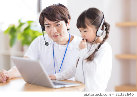 Girl taking lessons using a computer Girl taking lessons using a computer 81332640