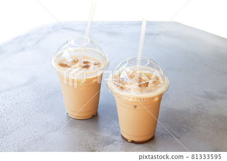 Iced coffee or latte in take away plastic cup on street cafe stone table 81333595