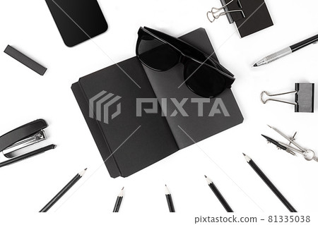 Blank notepad with clips, pens and glasses flat lay. 81335038